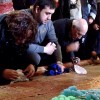 Christian worshipers in the Church of the Holy Sepulchre touch the marble Stone of Anointing, where Jesus’ body is said to have been prepared for burial.
