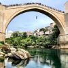 Not an easy way to make a buck. Young men jump off the reconstructed Ottoman-era Stari Most bridge in Mostar, asking tourists to contribute a few Euros for the entertainment. It's over 75 feet from the top of the bridge to the river below. #bosnia #bridge #potd
